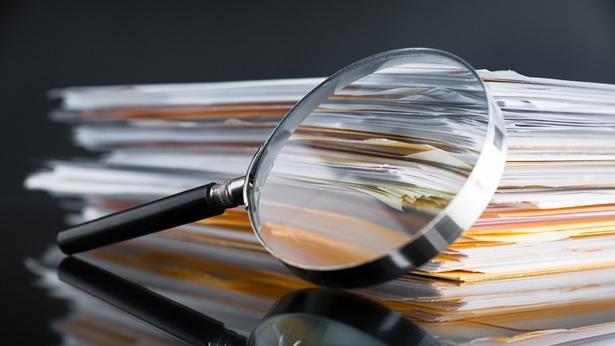 Magnifying glass in front of documents